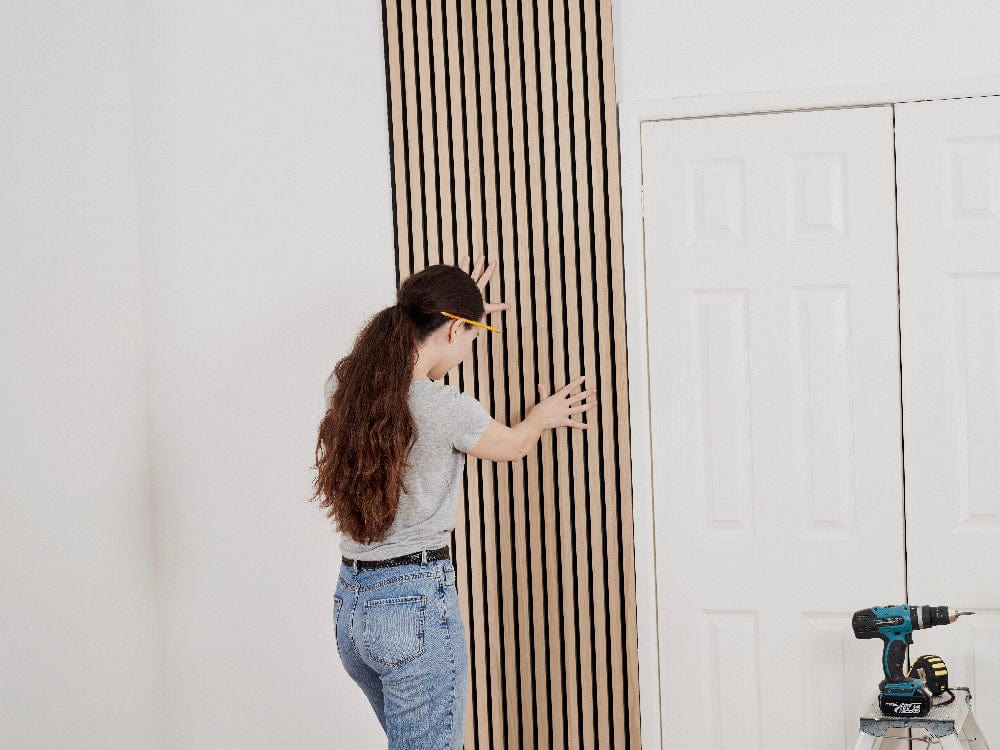 Step 5: Attach the panel to the wall. Hold the panel in place on the wall.