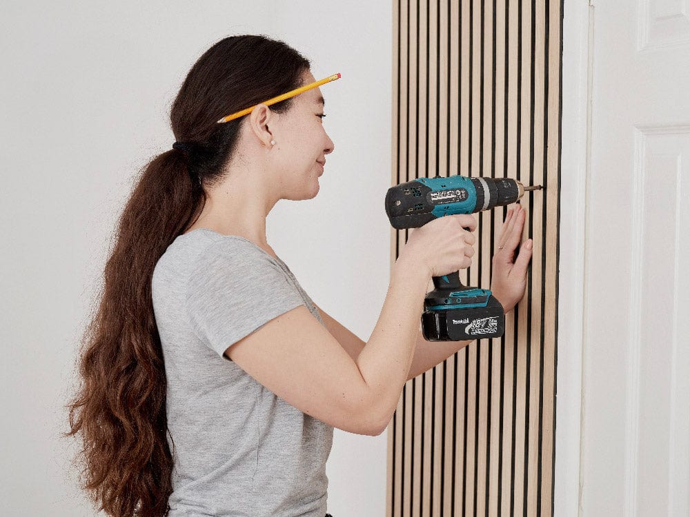 Step 6: Drill holes through the black felt into the wall.