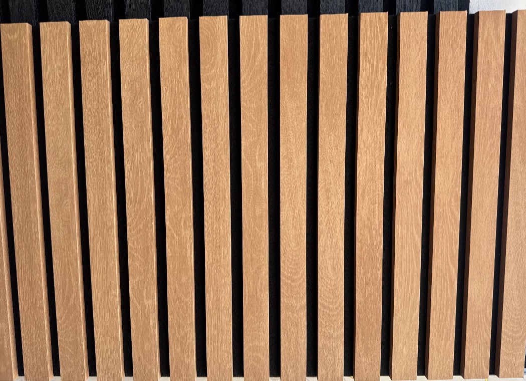 Claro Walnut photo detail showing warm wood slats on black felt - San Diego