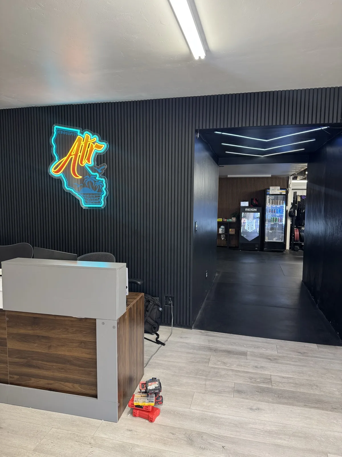Installed black oak 21 x 106 in acoustic slat panels at a commercial reception area