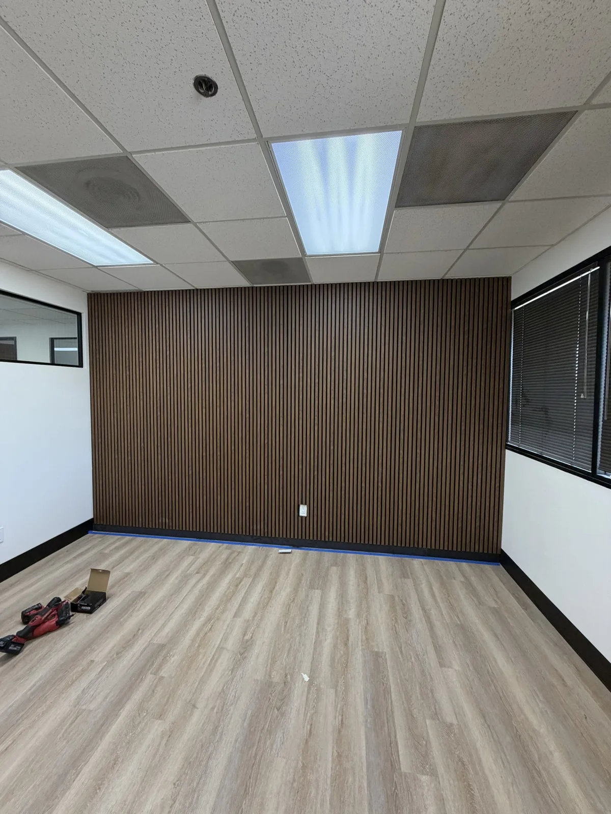 Finished office feature wall using Walnut 21 x 106 in acoustic slat panels