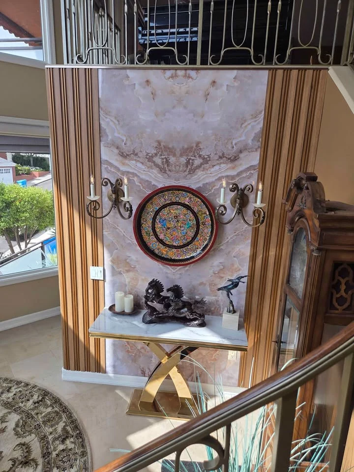 Golden Ice Jade bookmatch marble installed on a tall entry feature wall