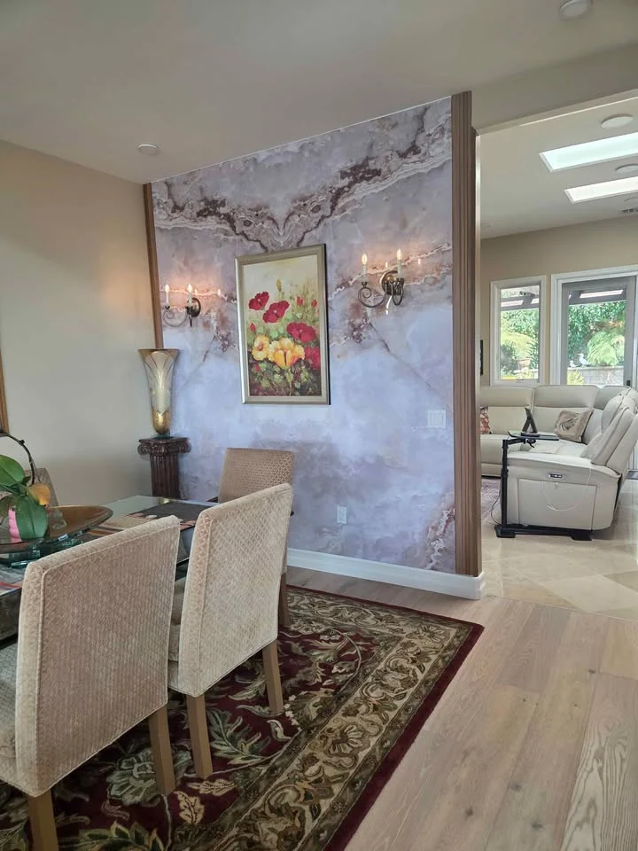 Golden Ice Jade bookmatch marble installed on a dining room feature wall