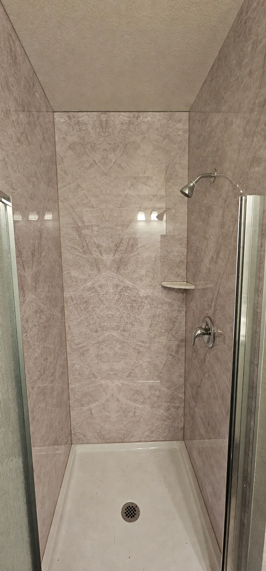 Customer shower installation using Taj Mahal bookmatch marble wall panels