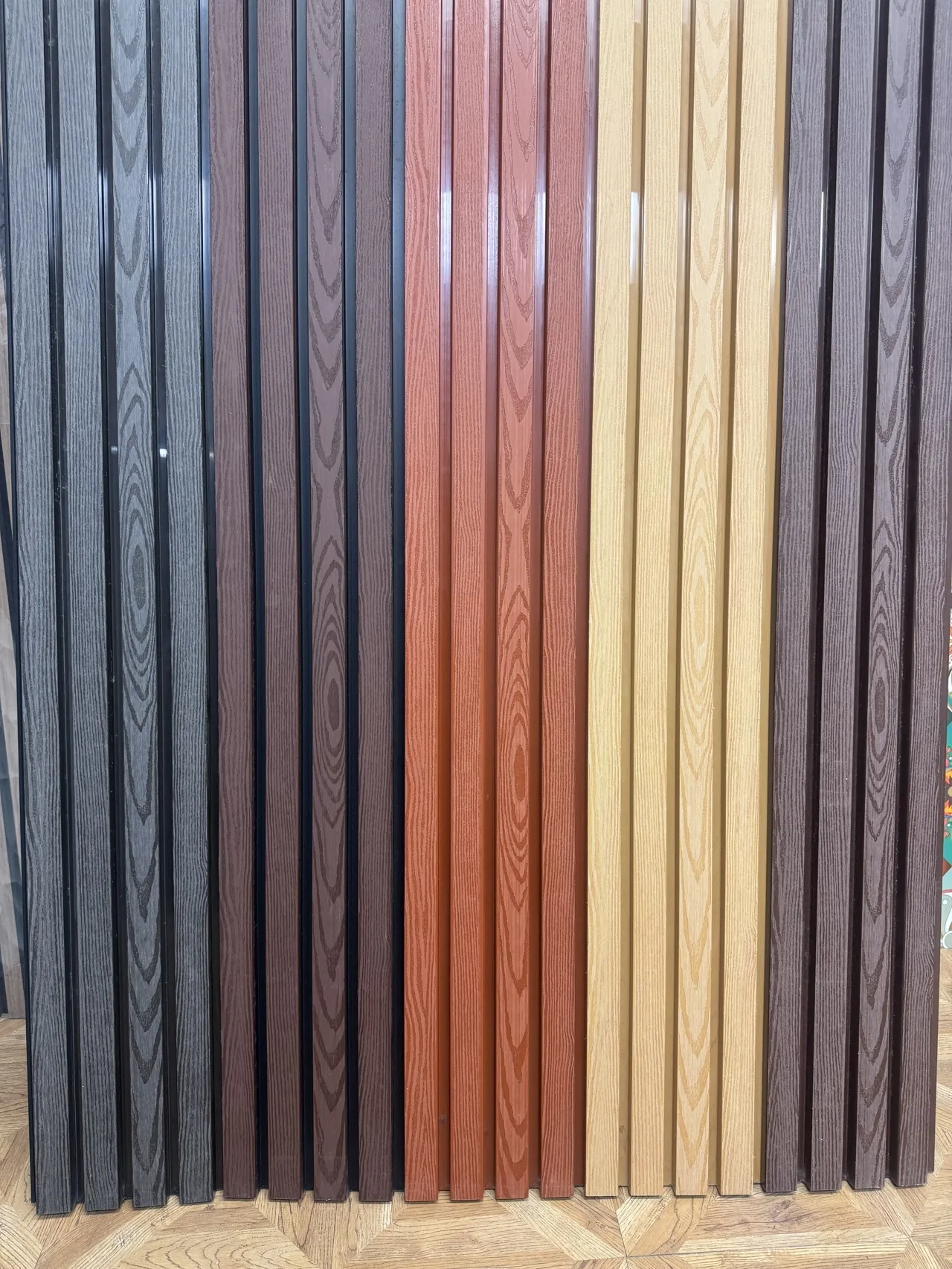 Wood-look ASA exterior slat panels shown in the current finish range
