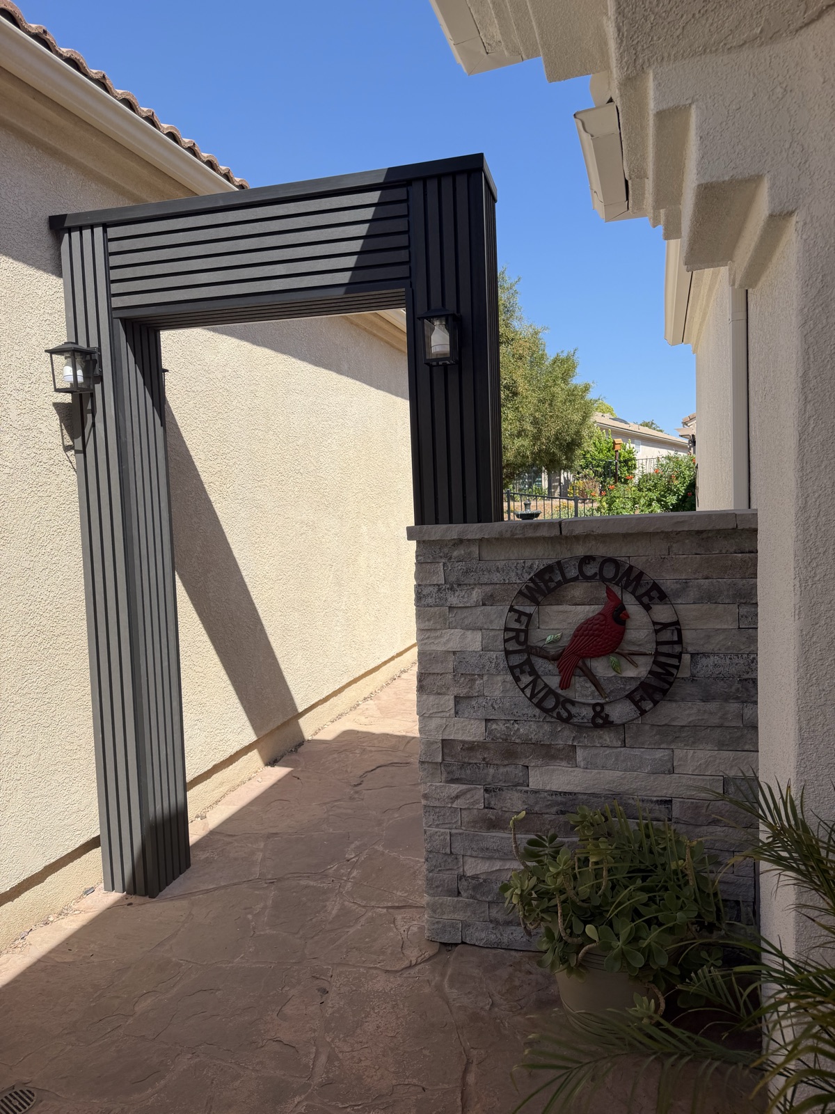 Customer-installed grey and black exterior composite cladding around an outdoor entry