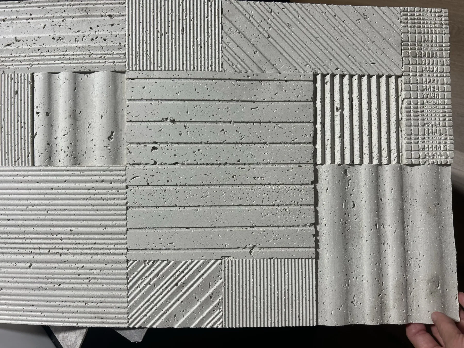 Flexible soft stone sample with mixed ribbed, wave, grid, and porous relief textures