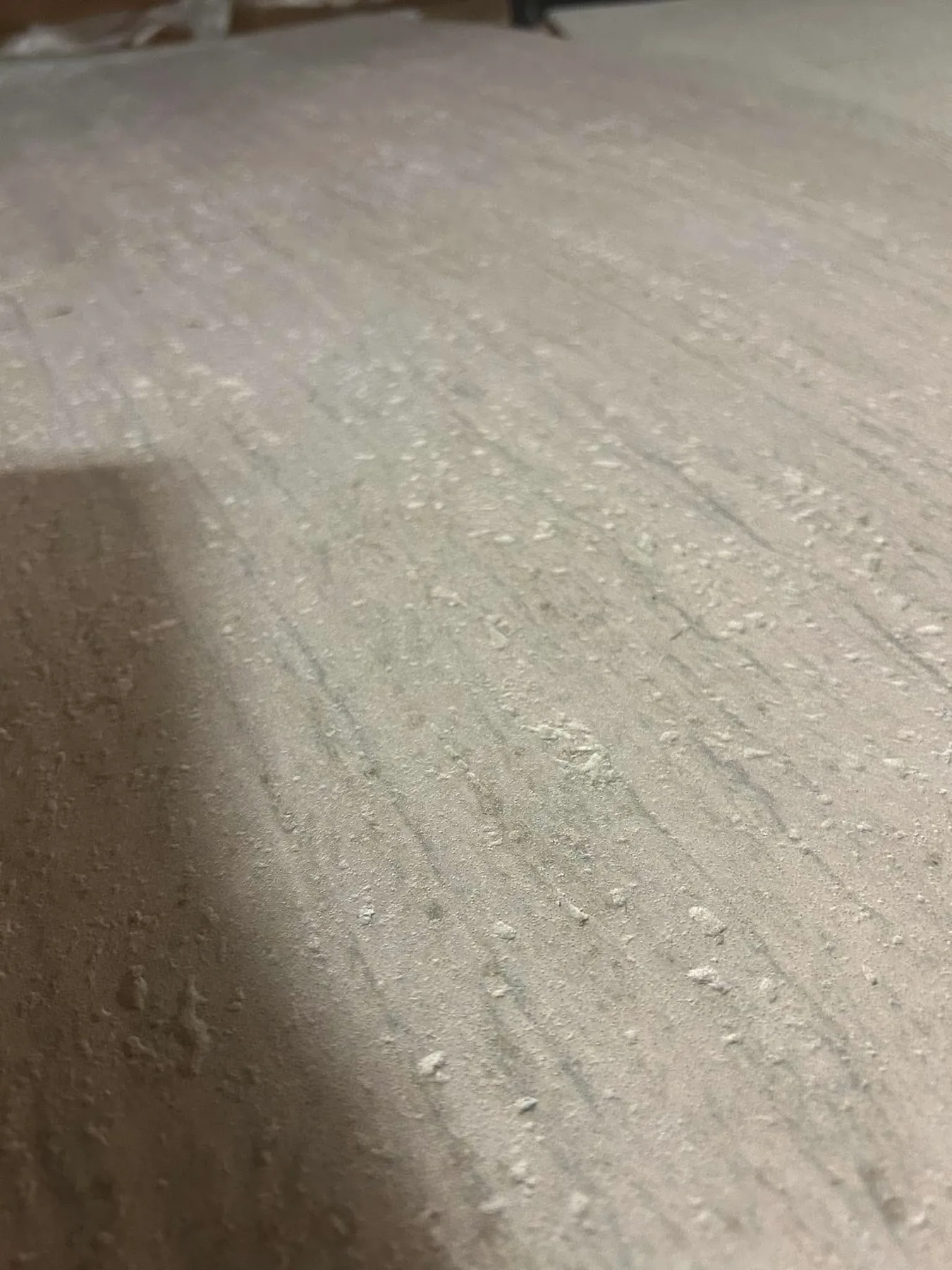 Warm light flexible stone with a porous mineral texture
