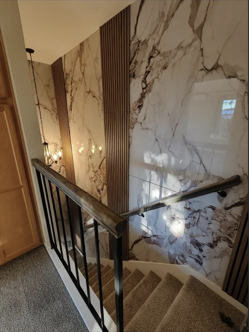 Alpine Ivory marble wall panels alongside dark fluted accents on a Castle Glen stairway