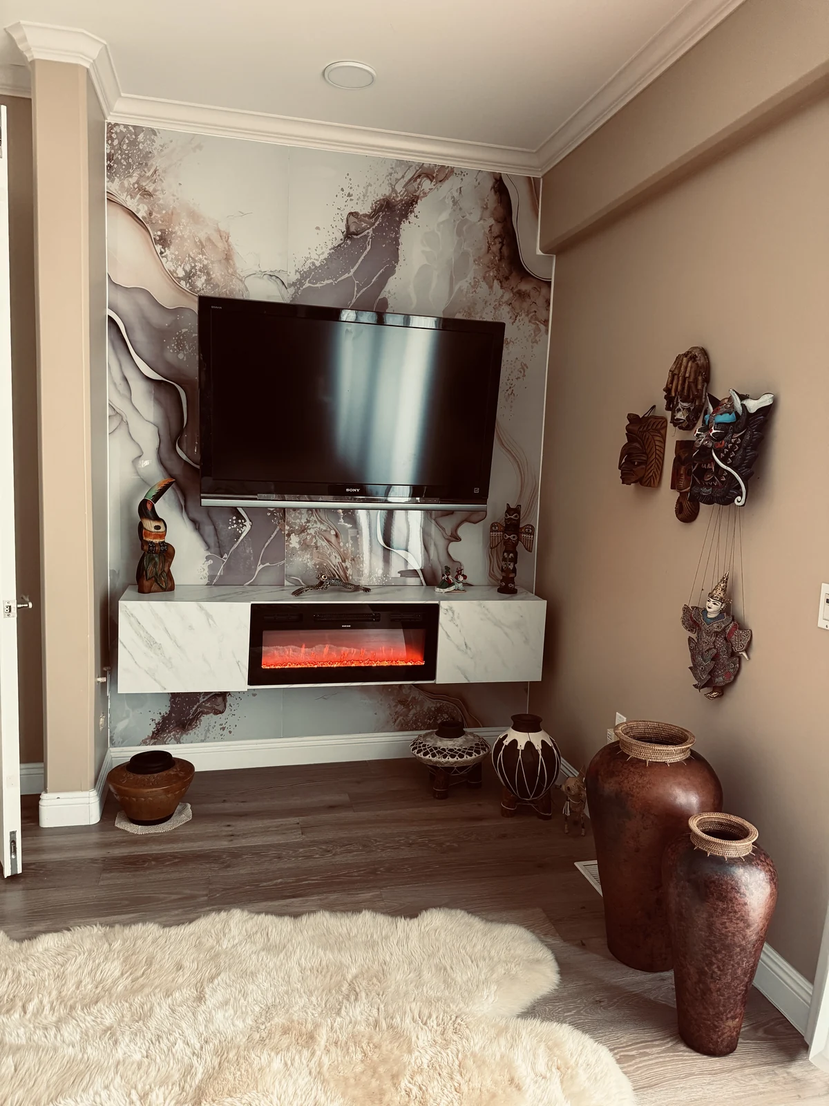 Yuliu Mountain PVC marble panels installed on a TV and fireplace feature wall