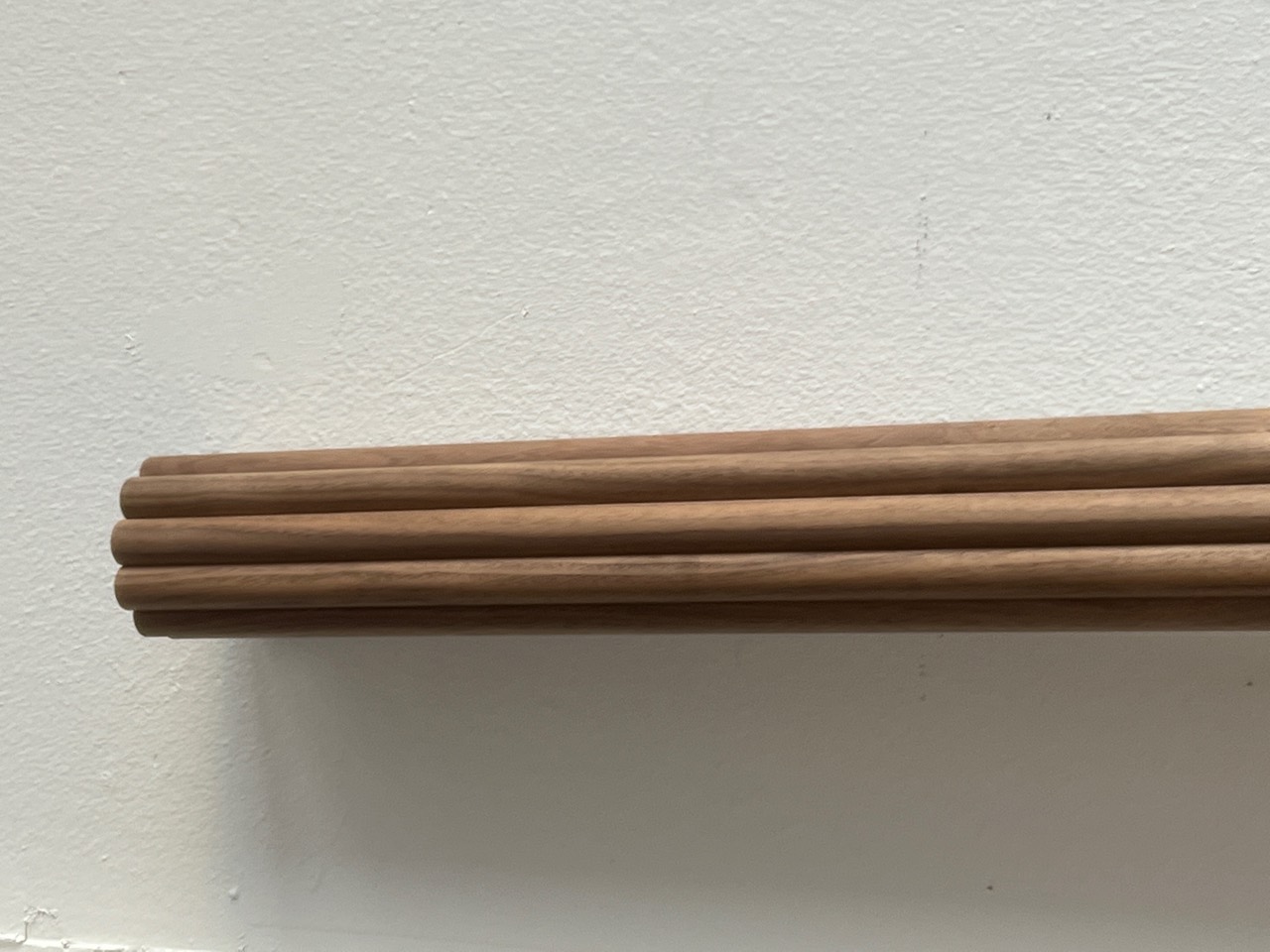 Upright flexible bamboo panel against a wall